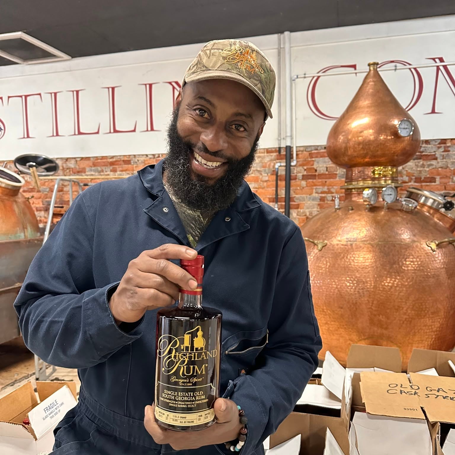 Master Distiller in Richland is smiling and showing off a bottle of 'America's Best Rum' (Forbes magazine) Richland Rum
